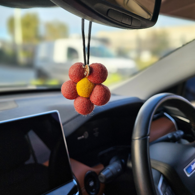 Red Hill Candle Co. Red Felt Air Freshener hanging in the car