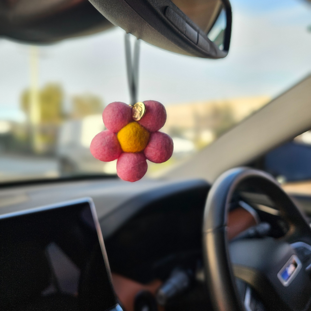 Red Hill Candle Co. Pink Felt Air Freshener hanging in the car