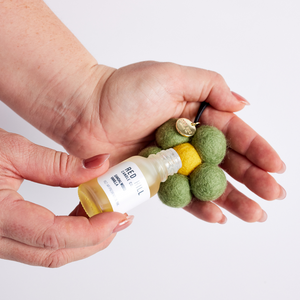 Australian Bush Felt Flower Air Freshener Oil being applied to felt ball air freshener shaped like a flower. 