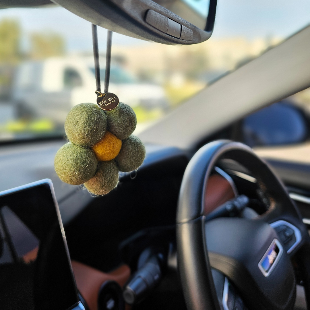 Red Hill Candle Co. Felt Air Freshener hanging in the car