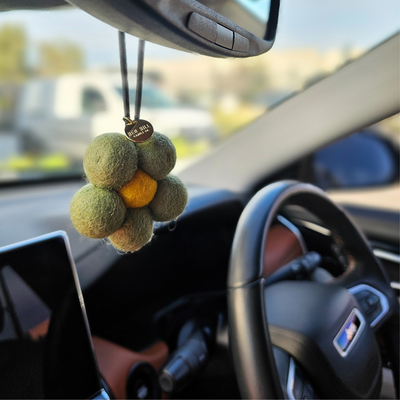 Red Hill Candle Co. Felt Air Freshener hanging in the car
